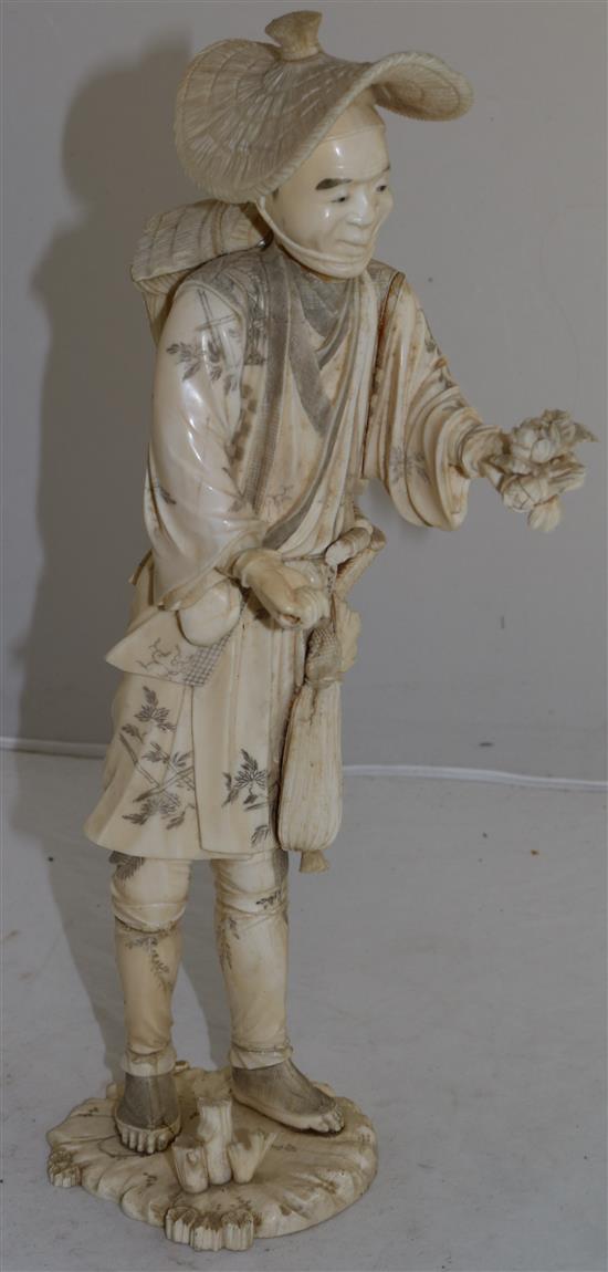 A large Japanese sectional ivory figure of a farmer, early 20th century, 36.5cm